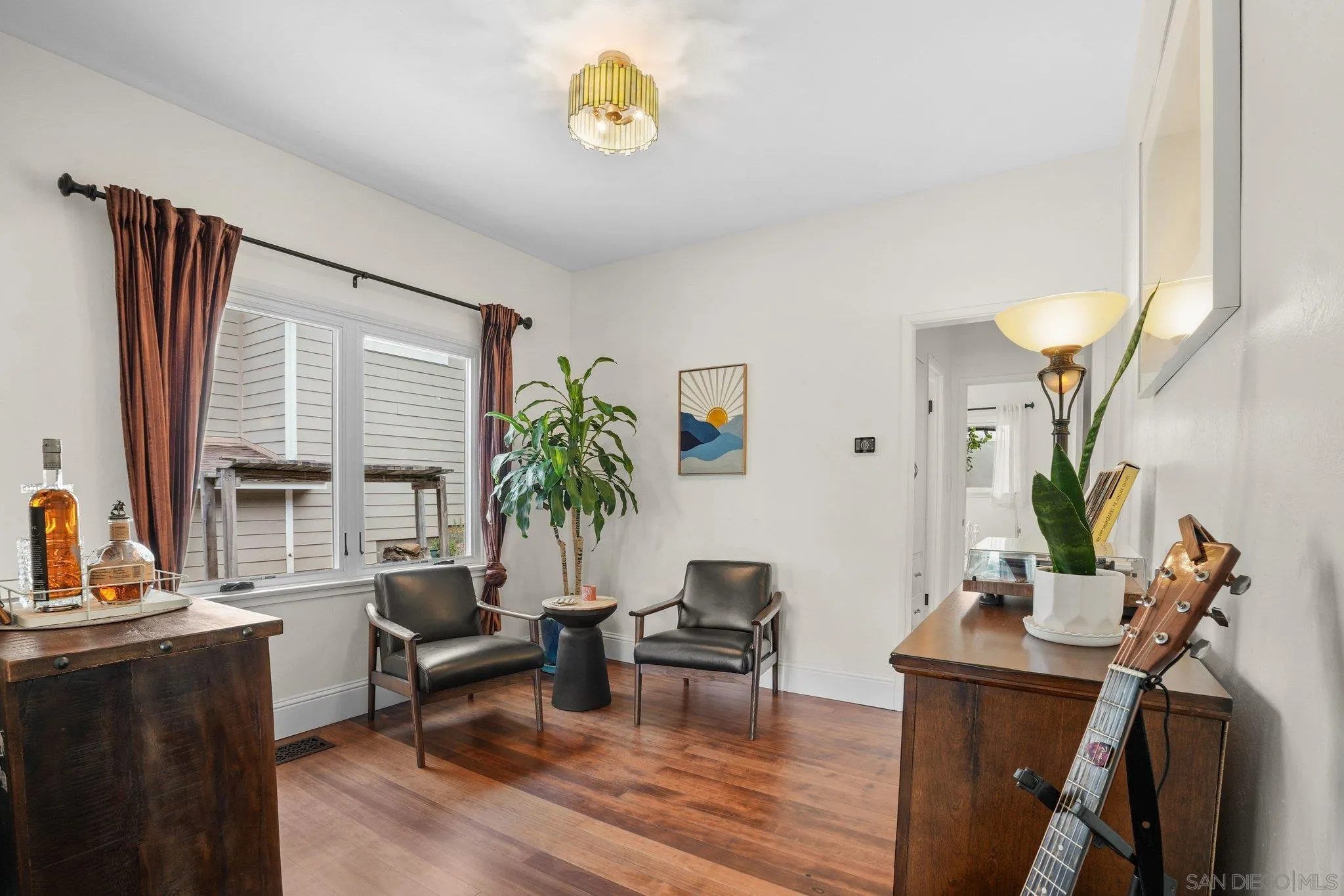 4635 4th Street La Mesa, CA 91941 - Photo 18 of 53 a living room with furniture a potted plant and a large window