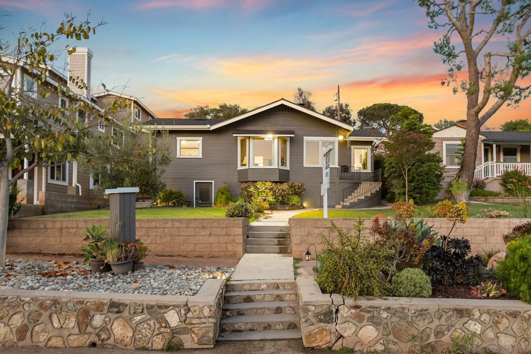 4635 4th Street La Mesa, CA 91941 - Photo 2 of 53 a front view of a house with a yard and fountain