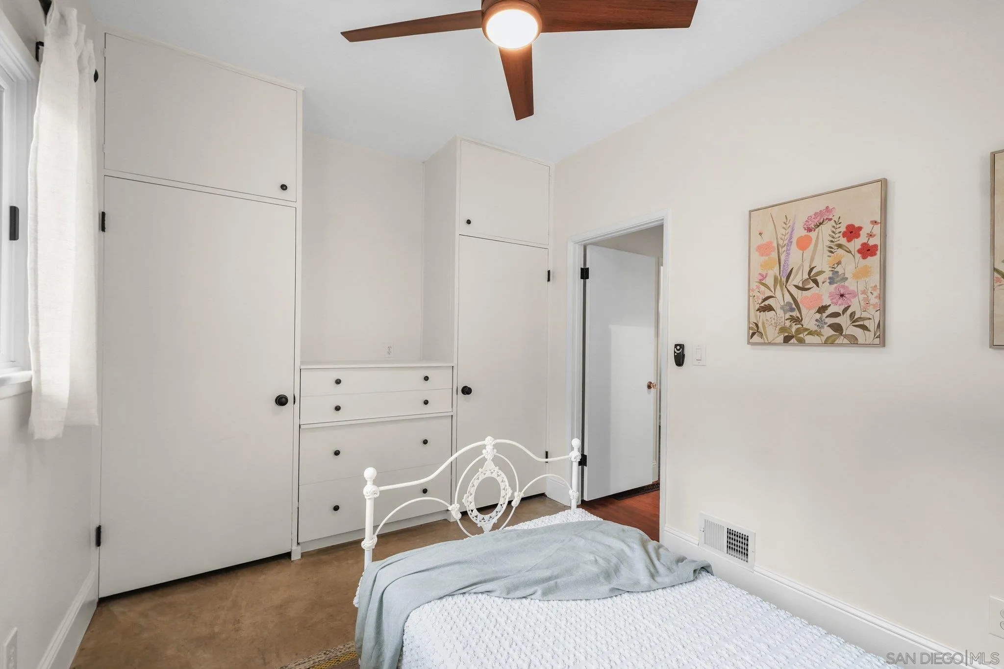 4635 4th Street La Mesa, CA 91941 - Photo 30 of 53 a bedroom with a bed and a chandelier