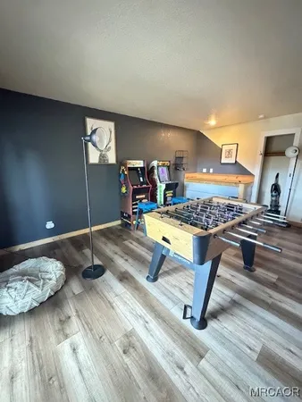 a view of a room with wooden floor and furniture