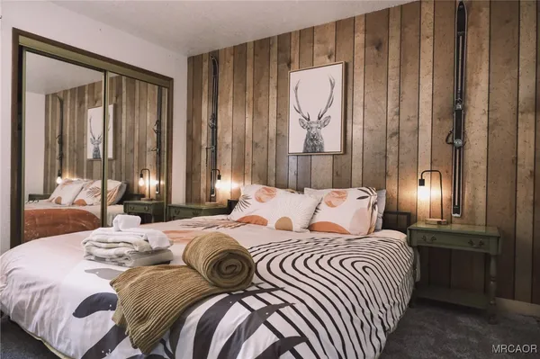 a bedroom with a bed and a chandelier
