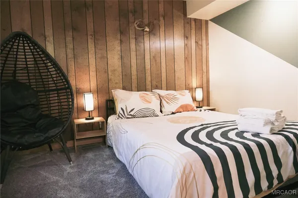 a bedroom with a bed and a chair