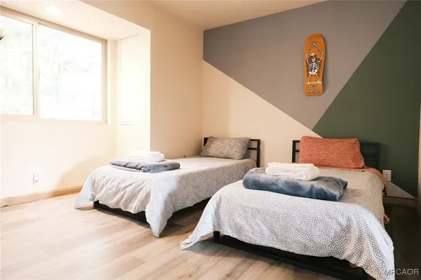 a bedroom with two beds and a window