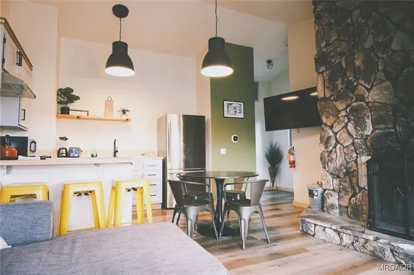 a kitchen with stainless steel appliances granite countertop a sink and a refrigerator
