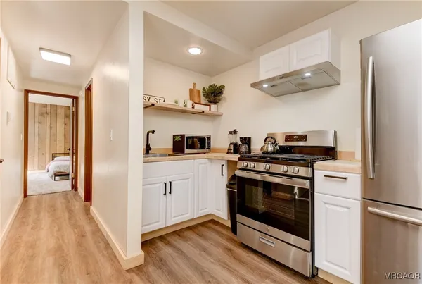 a kitchen with stainless steel appliances granite countertop a stove sink and refrigerator