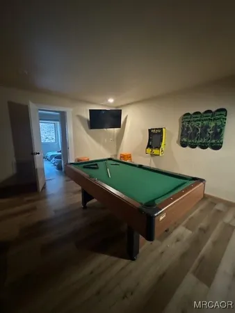 a room with pool table and windows