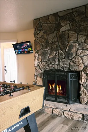 a living room with a fireplace and a flat screen tv