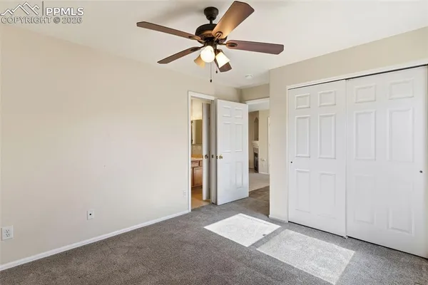 a view of an empty room with a ceiling fan