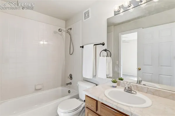 a bathroom with a sink toilet tub and shower