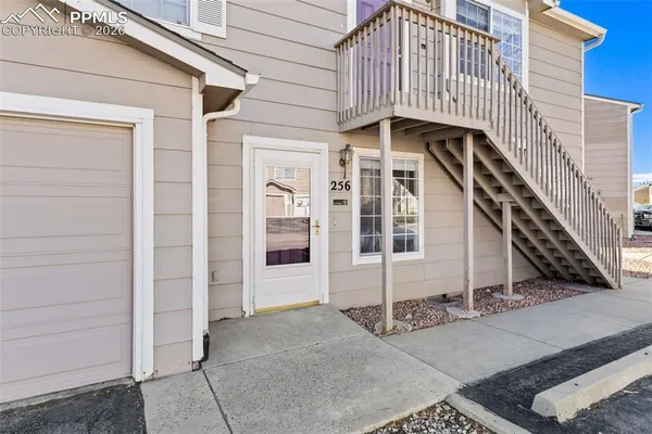 a view of a house with wooden fence