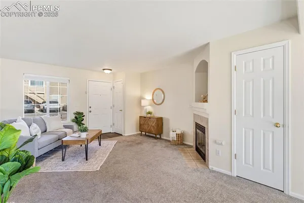 a living room with furniture and a fireplace