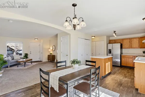 a view of a dining room with furniture and a chandelier