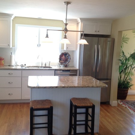 300 Newport Road Hull, MA 02045 - Photo 16 of 22 a kitchen with stainless steel appliances granite countertop a refrigerator and a wooden floor