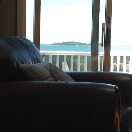 300 Newport Road Hull, MA 02045 - Photo 21 of 22 a living room with furniture and a floor to ceiling window