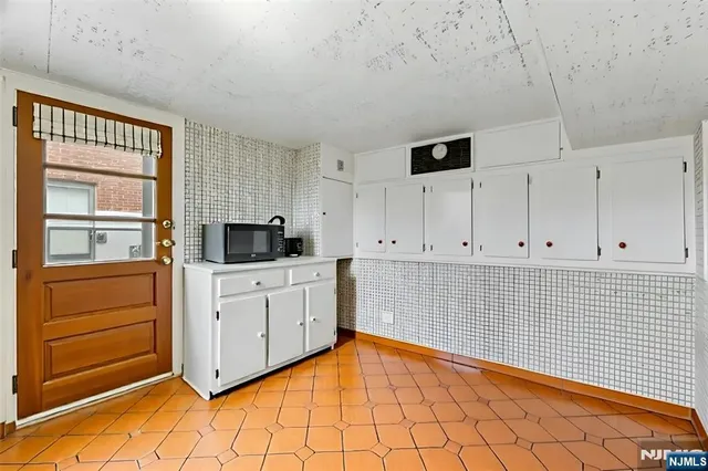 a view of kitchen with white cabinets