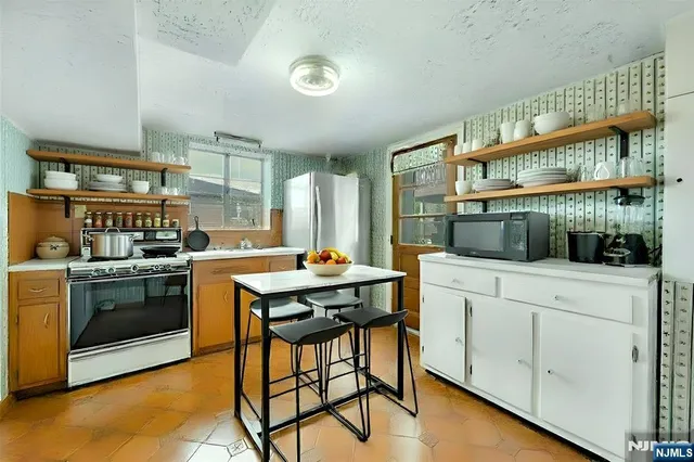 a kitchen with a stove a sink and cabinets