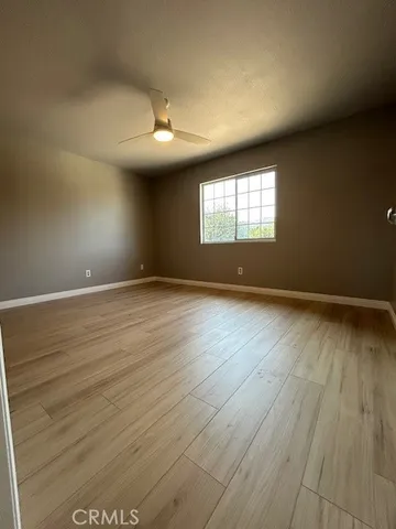 a view of a hallway with wooden floor and a fireplace