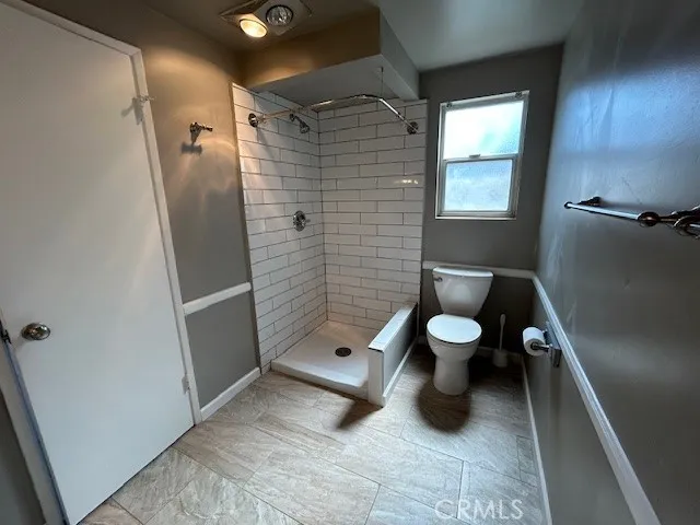 a kitchen with kitchen island stainless steel appliances a sink and a refrigerator