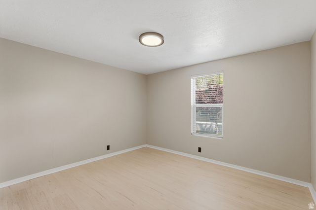 2875 North Hill Field Road, Unit 111 Layton, UT 84041 - Photo 17 of 30 Unfurnished room with light wood-style floors and baseboards