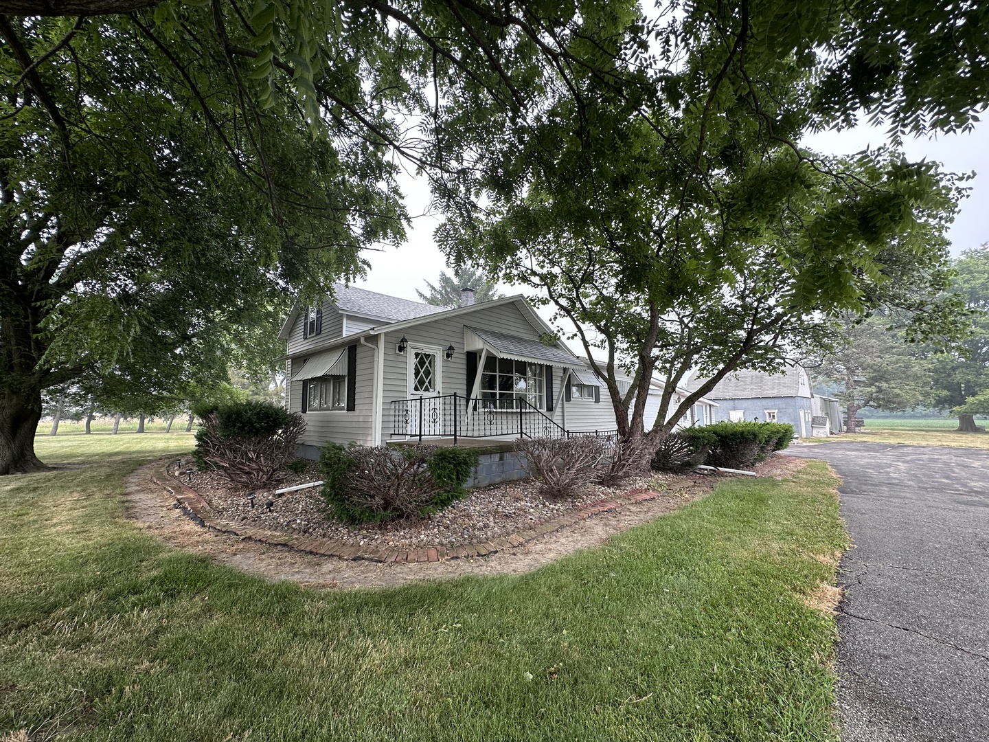 12454 Cracker Road Farmer City, IL 61842 - Photo 16 of 23 a front view of a house with a garden and trees