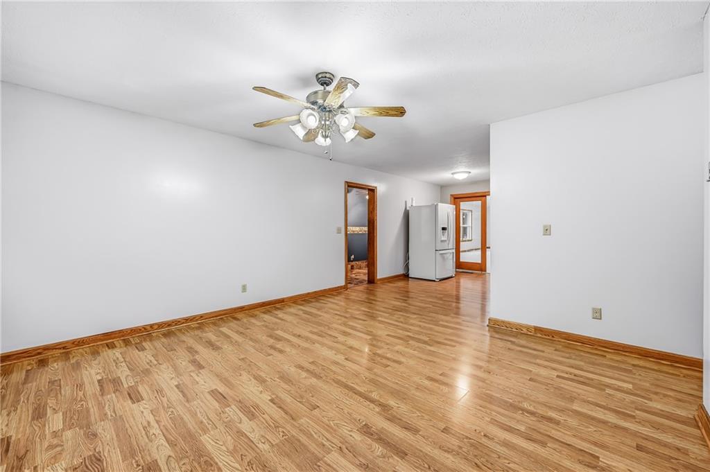 3451 East State Road Jamestown, PA 16134 - Photo 18 of 49 a view of an empty room with wooden floor and a ceiling fan