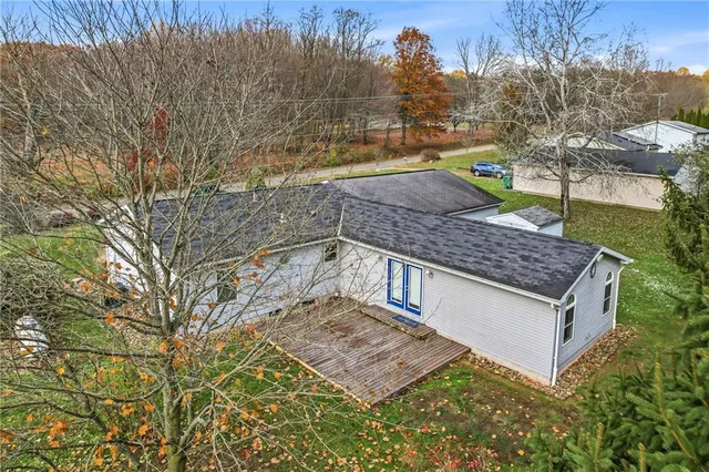 a wooden house with trees in front of it