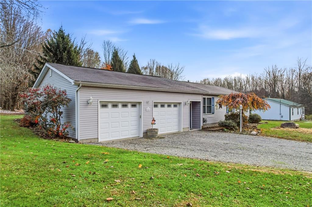 3451 East State Road Jamestown, PA 16134 - Photo 7 of 49 a front view of a house with a yard and garage