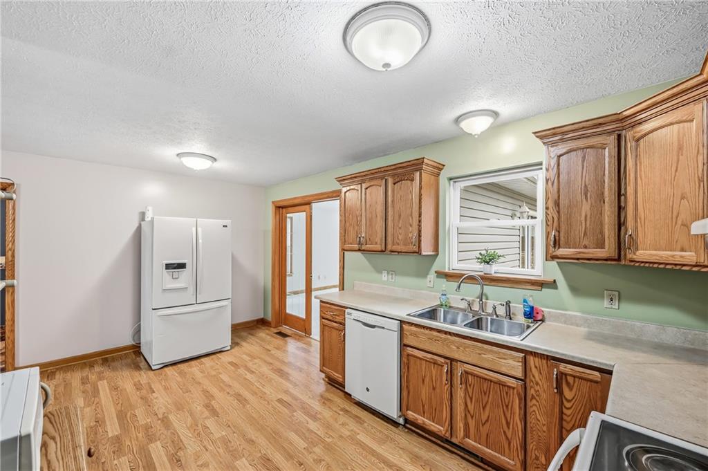 3451 East State Road Jamestown, PA 16134 - Photo 9 of 49 a kitchen with granite countertop a stove a sink and a refrigerator