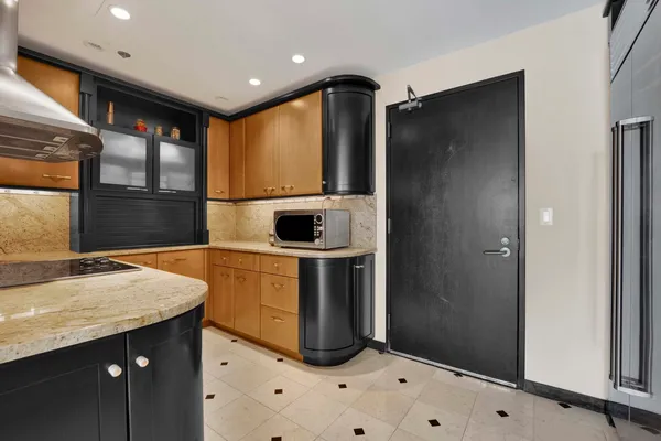 a kitchen with a refrigerator and a sink