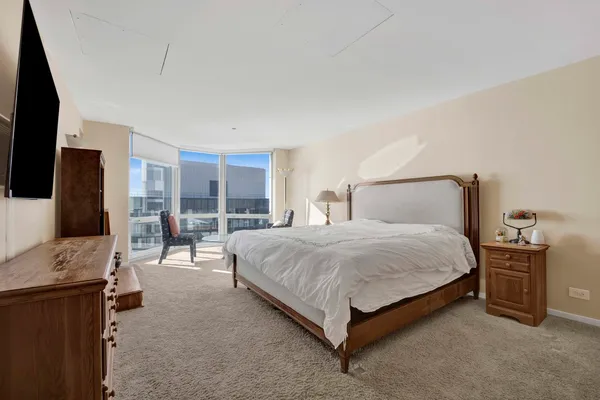 a bedroom with a bed and glass wall