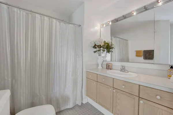 a bathroom with a granite countertop sink and a mirror