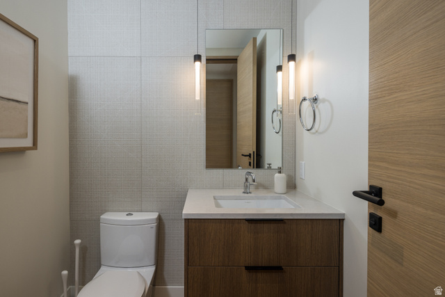 214 Lionsback Loop, Unit 37 Moab, UT 84532 - Photo 12 of 21 Modern vanity with a light wood-finish and integrated sink, complemented by a stone-finish countertop