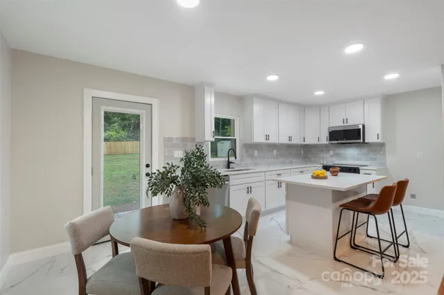 a kitchen with a table and chairs in it