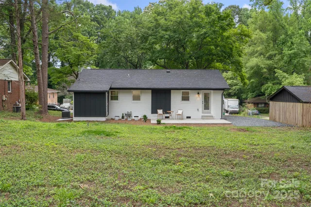 a front view of a house with yard patio and green space