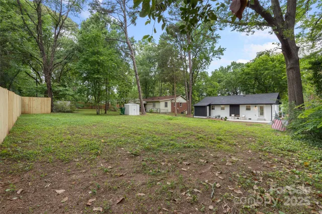 a view of a house with yard and a tree