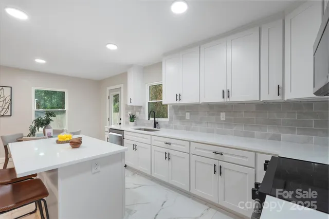 a kitchen with a sink a stove and cabinets