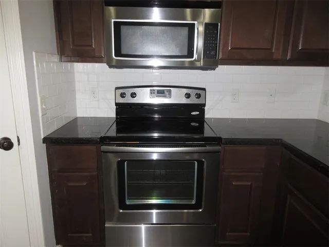 a stove top oven sitting inside of a kitchen