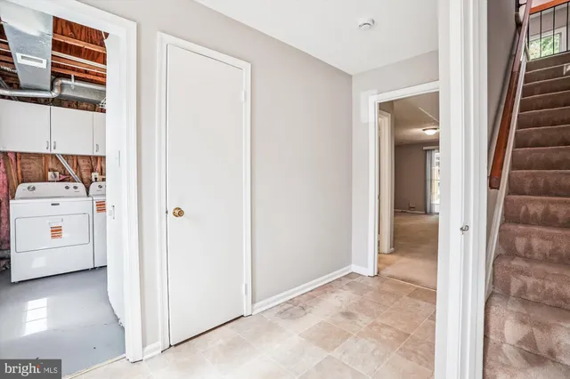 a view of walk in closet with white walls