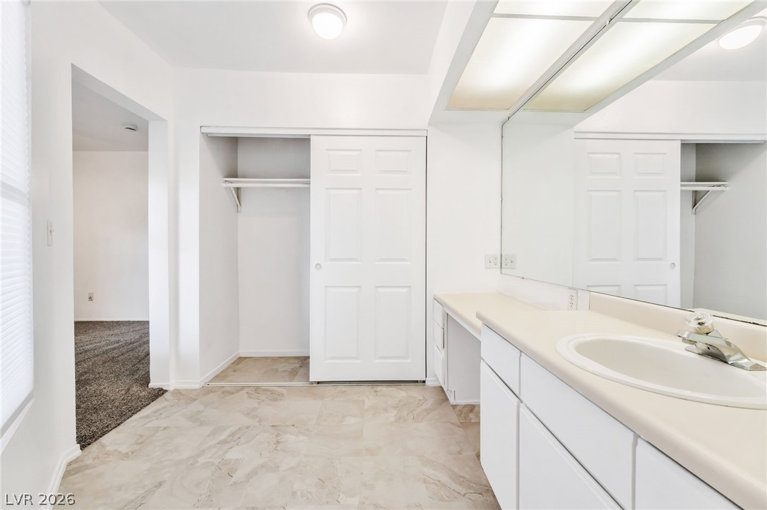 242 Nebraska Avenue Henderson, NV 89015 - Photo 19 of 46 Bathroom with vanity, closet, and new flooring