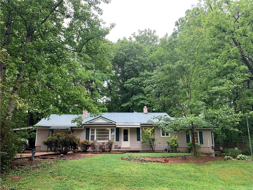 4680 Seward Road Pfafftown, NC 27040 - Photo 1 of 22 CHARMING HOME NESTLED ON 1.7 ACRES WITH OUTBUILDING, METAL ROOF, NEW PAINT, OVER SIZED DECK FOR ENTERTAINING