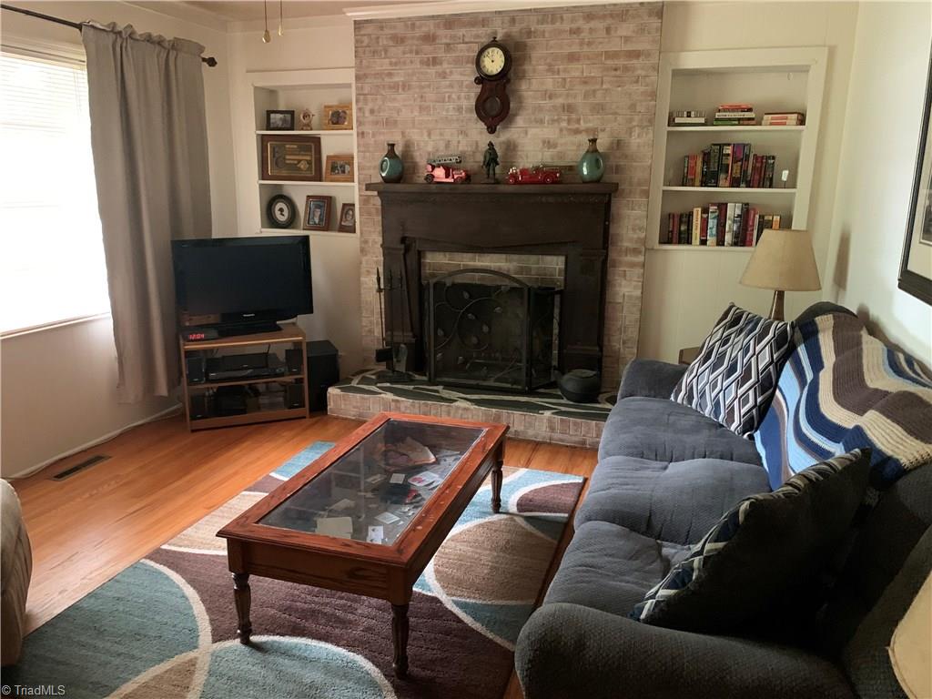 4680 Seward Road Pfafftown, NC 27040 - Photo 6 of 22 LIVING ROOM WITH HARDWOODS, WOOD BURNING FIREPLACE AND TONS OF NATURAL LIGHT