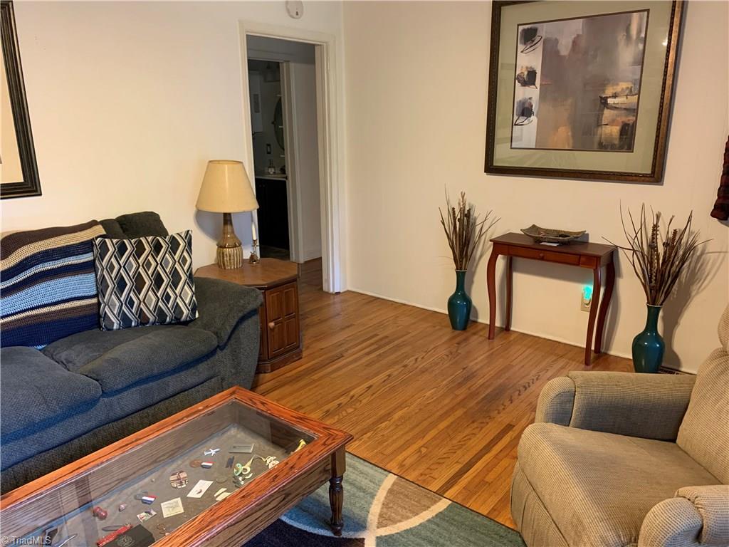 4680 Seward Road Pfafftown, NC 27040 - Photo 9 of 22 LIVING ROOM WITH HARDWOODS LOOKING INTO HALL