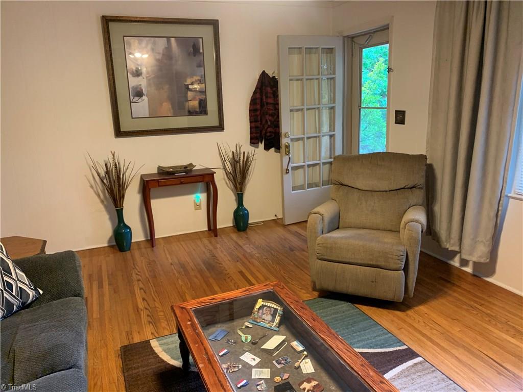 4680 Seward Road Pfafftown, NC 27040 - Photo 10 of 22 LIVING ROOM WITH HARDWOODS AND FIRE PLACE LOOKING OUT FRONT DOOR