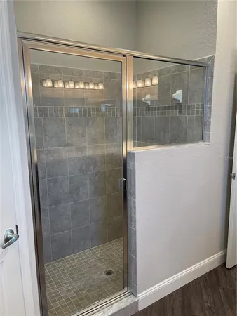 a bathroom with a glass shower door