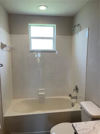 a bathroom with a toilet and a bathtub