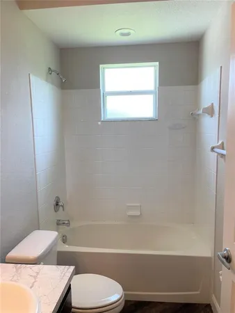 a bathroom with a toilet and a bathtub