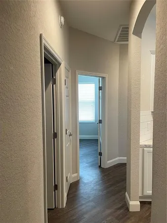 a view of a room with wooden floor