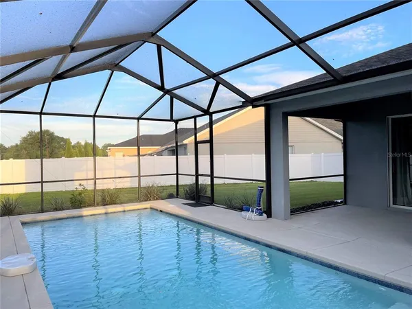 a view of a swimming pool with a patio