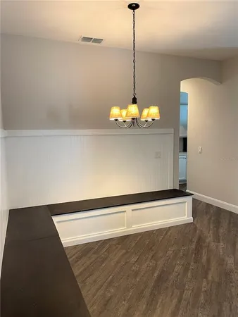 a view of an empty room with a chandelier