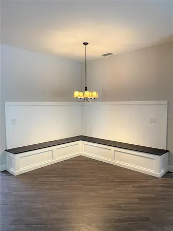 a an empty room with wooden floor